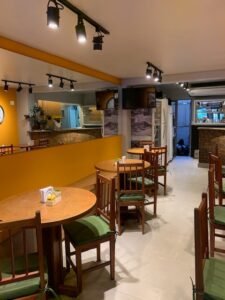 cafeteria com parede amarela e espelhos